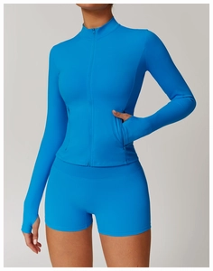 Detail of blue fitness jacket featuring thumbhole cuffs and hidden zipper pockets