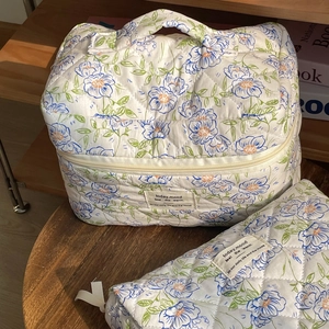 Detailed set of floral quilted cotton makeup bags with a handy handle and blue flower print