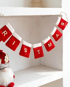 Detail of red sequined Christmas stocking banner with white faux fur and gold letters