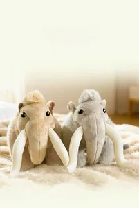 Detail of plush mammoth toys in brown and gray on a cozy rug for nursery decor