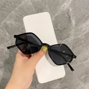 Modern black geometric hexagonal sunglasses with dark lenses and minimalist case