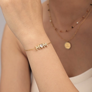 18K gold plated MOM letter bracelet with heart zircon worn on wrist with necklace