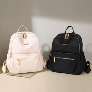 Close-up of nylon fabric texture and golden metal zippers on these stylish backpacks