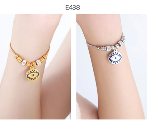 Detail of 18k gold plated evil eye charm bracelets with shimmering cubic zirconia beads