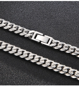 Macro shot of polished silver Cuban link necklace featuring a secure box clasp closure
