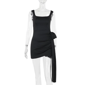 Detail of square neck black mini dress with side ruching and long streamer accents