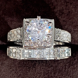 Silver tone bridal ring set featuring square halo cubic zirconia and matching pavé band