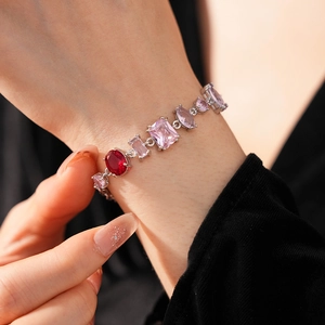 Detail of vintage zircon bracelet with pink and red gemstones on woman's wrist
