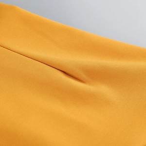Macro detail of high-density yellow woven fabric with elegant drape and fine texture