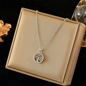 Detailed close-up of a silver Tree of Life pendant with zircon pave on a metal chain