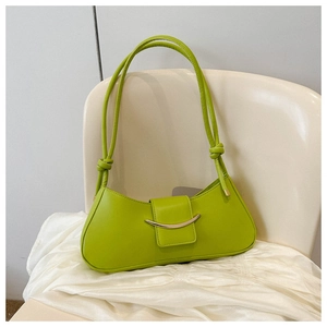 Detailed view of apple green underarm bag with knot strap and silver crescent hardware