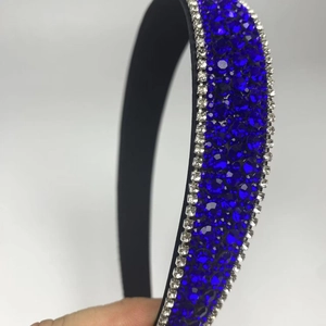Detailed view of the royal blue rhinestones and white crystal edges on the black headband