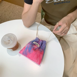 Detailed view of tie-dye corduroy drawstring bag with soft pink and blue textures