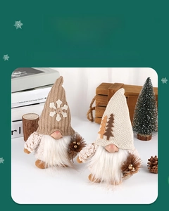 Detail of two Christmas gnomes with knit hats and faux fur beards on a cozy festive table