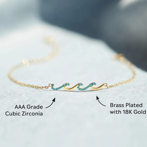 Minimalist wave charm bracelet in 18K gold plated brass with blue zirconia stones