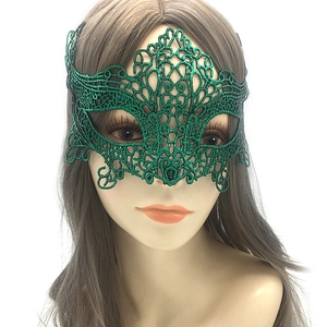 Detail of green lace masquerade mask with intricate floral embroidery for Halloween costume