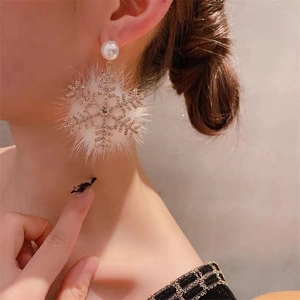 Elegant snowflake earrings with white fur ball and pearl accents for festive occasions