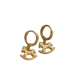 Elegant gold rocking horse pendant earrings with textured finish on a white background