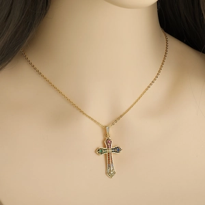 Gold cross necklace featuring vibrant multi-colored cubic zirconia stones on a model