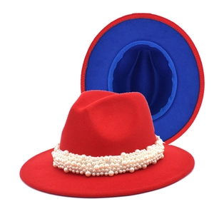 Detail view of red wool fedora hat with white pearl band and royal blue inner lining