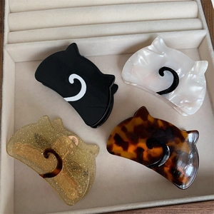 Set of four cute cat-shaped acetate hair claws in black, pearl white, and tortoiseshell