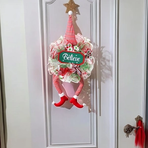 Christmas elf door wreath with striped legs and Believe sign for festive decoration