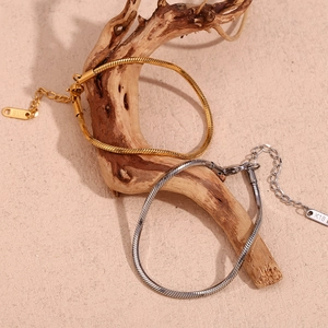 Detail of 18K gold and silver snake chain bracelets with lobster clasp and K18 tag