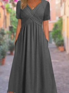 Detail of grey V-neck maxi dress featuring side pockets and a cinched waist design