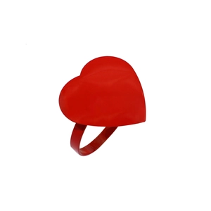 Macro shot of a glossy red solid heart decoration on a smooth metallic napkin ring