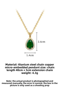 Macro shot of green teardrop zircon pendant with titanium steel gold-plated chain details