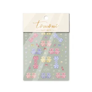 Detailed view of 5D embossed nail art stickers featuring macaron teddy bears and bows