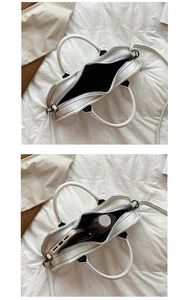 Internal view of the white punk bat handbag showing capacity for umbrella and phone