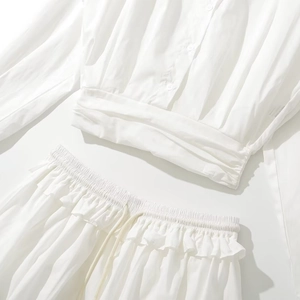 Two-piece college style outfit with white long-sleeve lapel shirt and belted mini skirt