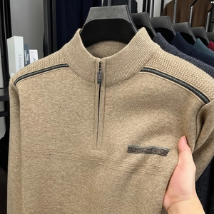 Detail of khaki men's quarter-zip knit sweater showing fine texture and accent stripes