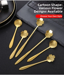 Close-up of golden stainless steel spoons in cherry blossom and rose flower shapes
