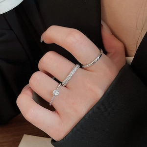 Detail of silver stackable rings set with zircon stones on model's hand