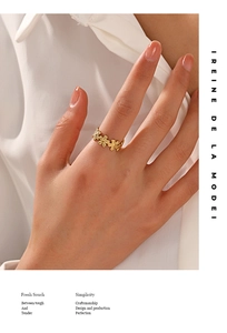 Close-up of golden daisy flower wrap ring showing intricate floral details on model finger