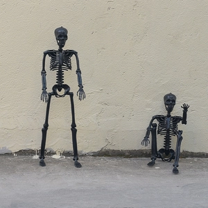 Detailed view of realistic black plastic skeleton props for Halloween bar decoration