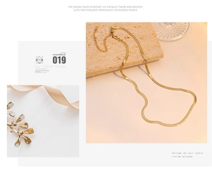 Detailed view of elegant gold snake chain necklace with lobster clasp and extender