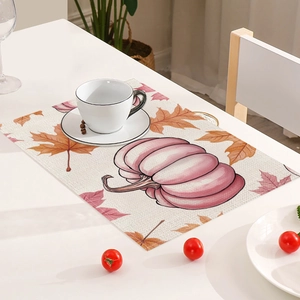 Detail of pumpkin and maple leaf print on a rectangular heat resistant table mat