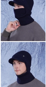 Macro detail of navy knit neck gaiter and peak hat showing the winter texture