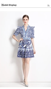 Detail of blue and white porcelain floral print dress with V-neck and ruffled sleeves