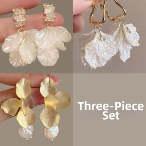 Detailed views of a 3-piece floral earring set with shell petals and faux pearls
