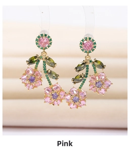Macro detail of floral drop earrings with pink, purple, and green cubic zirconia crystals