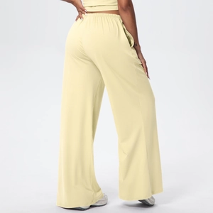 Detail view of high-waist loose drawstring wide-leg pants in soft cream fabric from behind