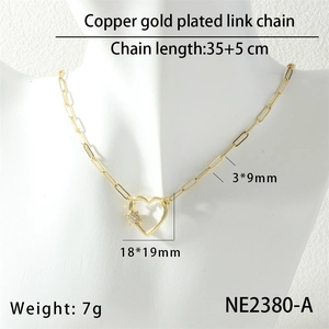Macro shot of gold-plated heart pendant necklace on model showing its fine 35cm chain