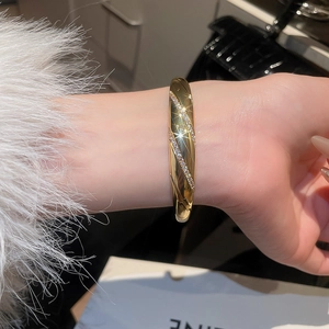 Detail shot of 18k gold plated bracelet featuring diagonal textures and zircon pavé