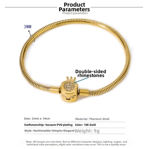 Detailed macro of 18K gold plated seashell clasp on 3mm titanium snake chain bracelet