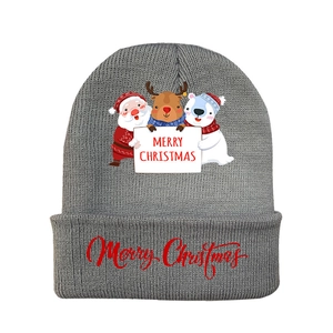 Detail of grey knitted Christmas beanie with festive patterns and Merry Christmas text