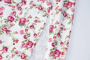 Detailed macro view of high-quality floral fabric featuring a side slit on a summer dress